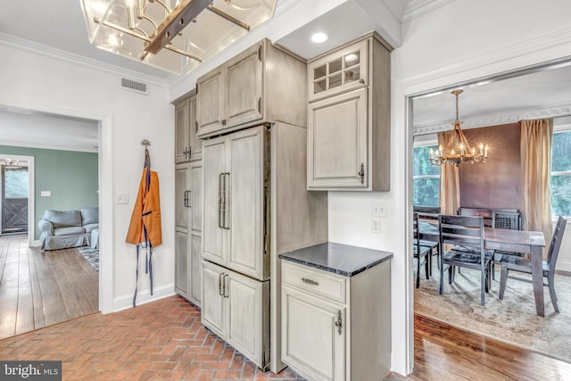 65 Hillcrest Ln, North East, MD 21901 - kitchen with a chandelier, baseboards, crown molding, brick flooring, and glass insert cabinets