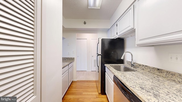 1808 Old Meadow Rd Unit 1015, Mclean, VA 22102 - kitchen featuring stainless steel appliances, a sink, light stone countertops, light wood-style flooring, and white cabinets