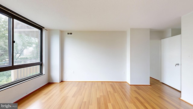 1808 Old Meadow Rd Unit 1015, Mclean, VA 22102 - unfurnished room featuring healthy amount of natural light, light wood-style flooring, and baseboards