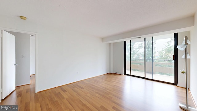 1808 Old Meadow Rd Unit 1015, Mclean, VA 22102 - spare room featuring wood finished floors and a smoke detector