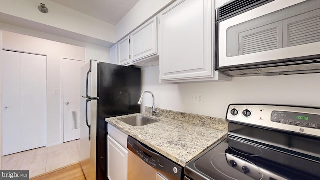1808 Old Meadow Rd Unit 1015, Mclean, VA 22102 - kitchen featuring stainless steel appliances, a sink, white cabinetry, and light stone counters