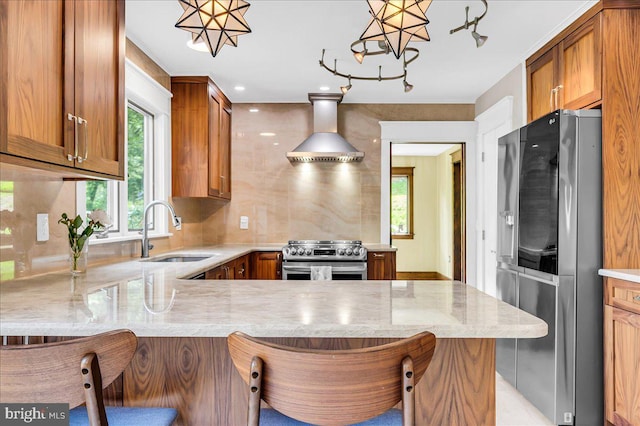 13 Quartz Mill Rd, Newark, DE 19711 - kitchen with appliances with stainless steel finishes, a sink, wall chimney exhaust hood, a peninsula, and brown cabinetry