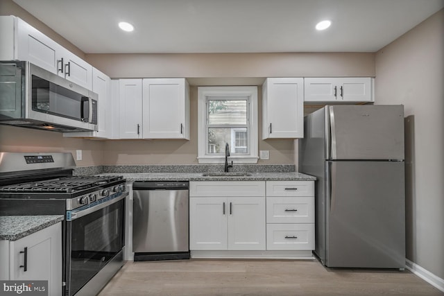 5010 54th Ave, Hyattsville, MD 20781 - kitchen with stainless steel appliances, a sink, white cabinetry, and recessed lighting