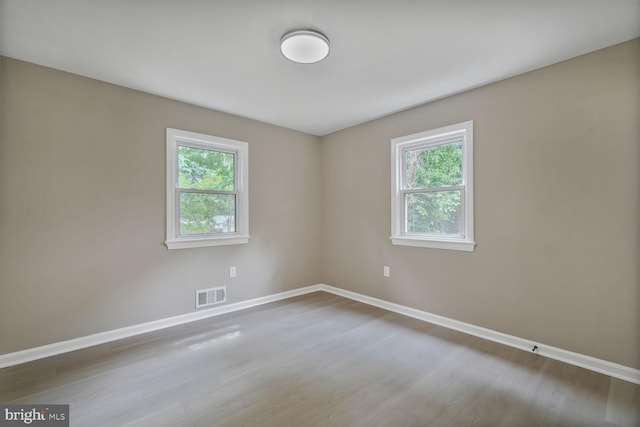 5010 54th Ave, Hyattsville, MD 20781 - spare room featuring plenty of natural light, baseboards, and wood finished floors