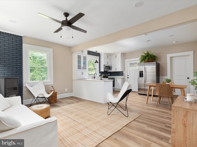 30 Gooney Falls Ln, Front Royal, VA 22630 - living room with healthy amount of natural light, light wood-style floors, ceiling fan, and a fireplace