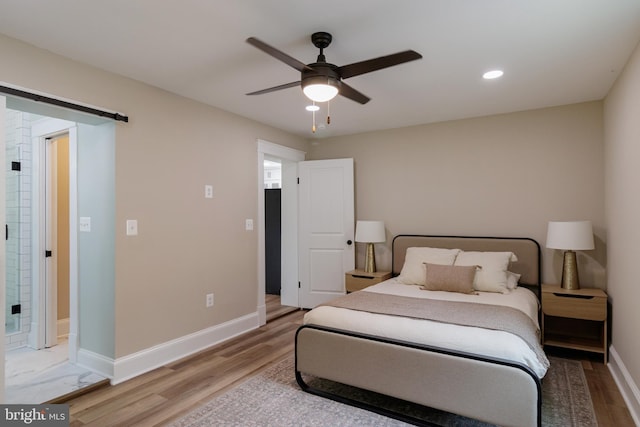 30 Gooney Falls Ln, Front Royal, VA 22630 - bedroom with light wood-type flooring, baseboards, recessed lighting, a barn door, and a ceiling fan