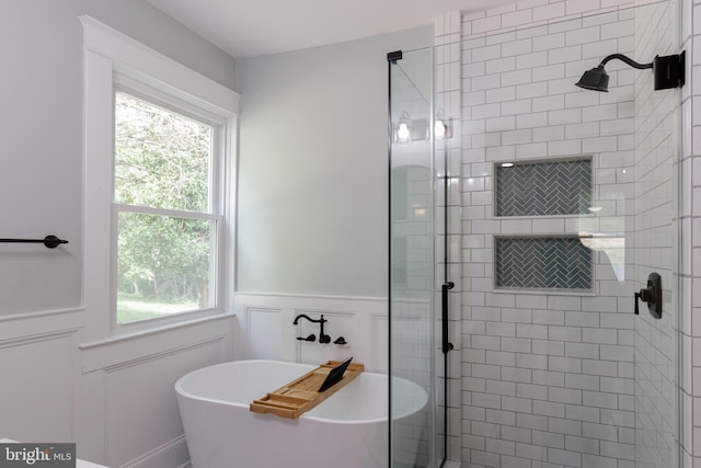 30 Gooney Falls Ln, Front Royal, VA 22630 - bathroom with a shower stall, plenty of natural light, a soaking tub, a decorative wall, and a wainscoted wall