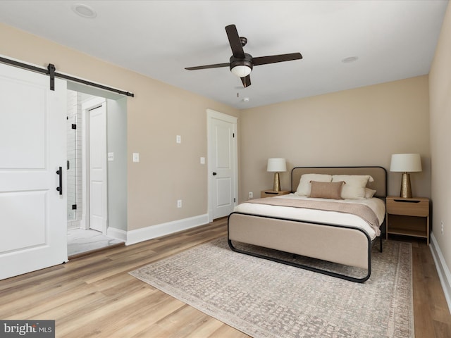 30 Gooney Falls Ln, Front Royal, VA 22630 - bedroom featuring light wood finished floors, a barn door, baseboards, and ceiling fan