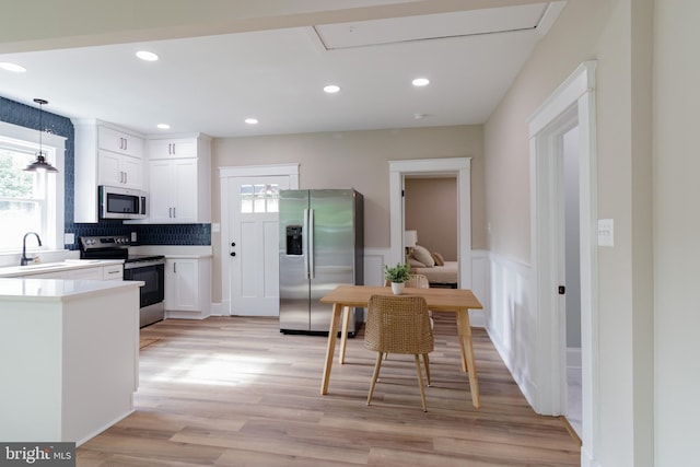 30 Gooney Falls Ln, Front Royal, VA 22630 - kitchen featuring appliances with stainless steel finishes, healthy amount of natural light, white cabinets, light wood-style floors, and recessed lighting