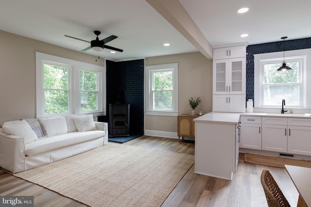 30 Gooney Falls Ln, Front Royal, VA 22630 - living room with a wood stove, light wood-type flooring, baseboards, ceiling fan, and recessed lighting