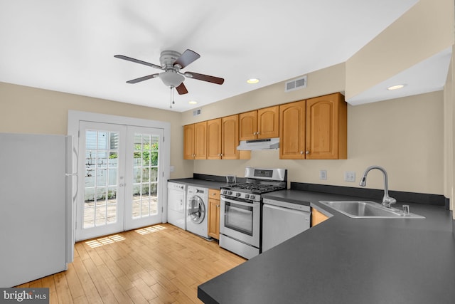 109 E Clement St, Baltimore, MD 21230 - kitchen featuring freestanding refrigerator, washer / clothes dryer, stainless steel gas range, french doors, and under cabinet range hood