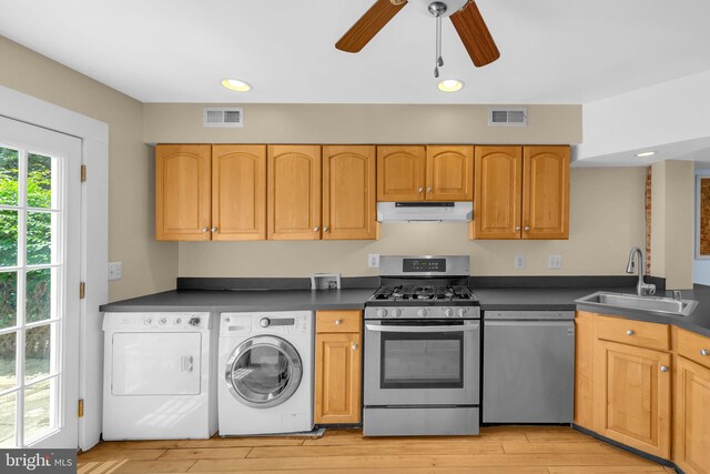 109 E Clement St, Baltimore, MD 21230 - kitchen with stainless steel appliances, under cabinet range hood, dark countertops, independent washer and dryer, and recessed lighting