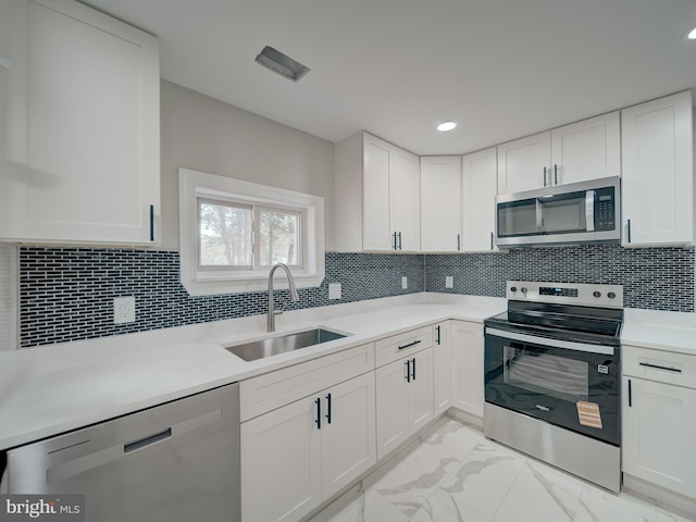 401 Bryan Point Rd, Accokeek, MD 20607 - kitchen with stainless steel appliances, light marble finish floors, light countertops, white cabinets, and recessed lighting