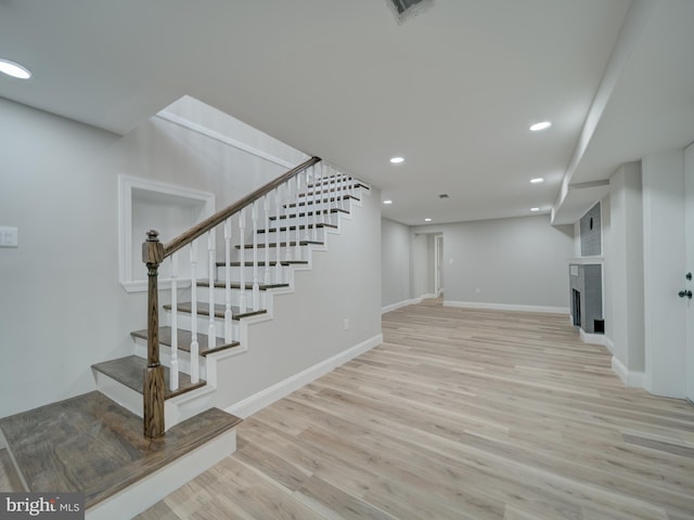 401 Bryan Point Rd, Accokeek, MD 20607 - finished basement featuring stairs, wood finished floors, recessed lighting, and a fireplace