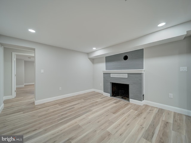 401 Bryan Point Rd, Accokeek, MD 20607 - unfurnished living room with recessed lighting, light wood-type flooring, and a fireplace