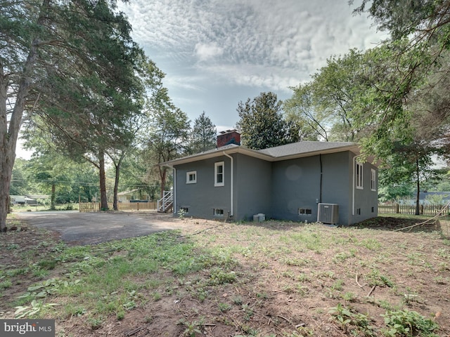 401 Bryan Point Rd, Accokeek, MD 20607 - view of property exterior with a chimney and a central AC unit
