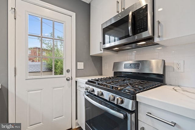 5054 8th St NE, Washington, DC 20017 - kitchen featuring appliances with stainless steel finishes, backsplash, light countertops, and white cabinetry