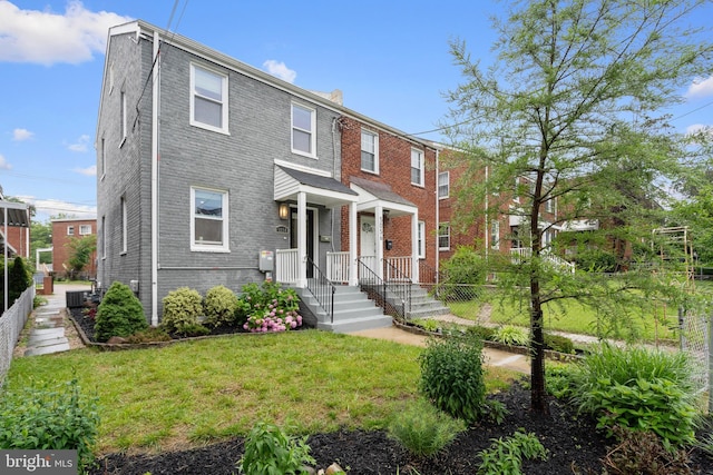 5054 8th St NE, Washington, DC 20017 - view of property with central air condition unit, a front yard, and brick siding