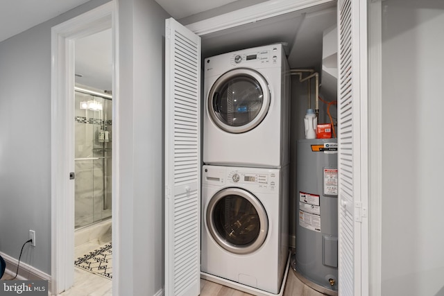 5054 8th St NE, Washington, DC 20017 - laundry area with stacked washing machine and dryer, water heater, wood finished floors, and baseboards