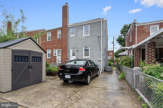 5054 8th St NE, Washington, DC 20017 - back of house featuring cooling unit, a chimney, and brick siding