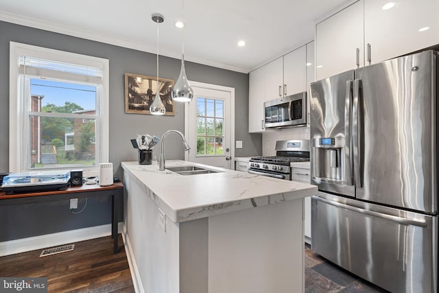 5054 8th St NE, Washington, DC 20017 - kitchen with appliances with stainless steel finishes, a sink, ornamental molding, white cabinets, and a peninsula