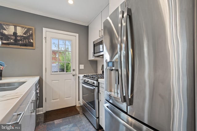 5054 8th St NE, Washington, DC 20017 - kitchen featuring stainless steel appliances, dark stone finish floors, ornamental molding, white cabinetry, and recessed lighting