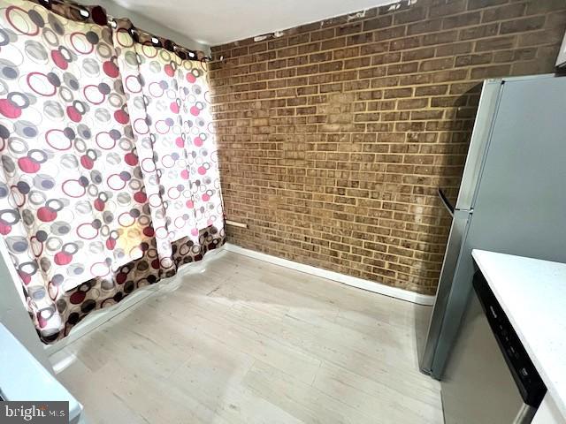 3354 Huntley Square Dr Unit T2, Temple Hills, MD 20748 - unfurnished room with brick wall, baseboards, and wood finished floors