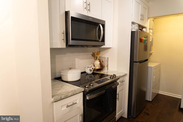 919 W Montgomery Ave Unit 1-5, Bryn Mawr, PA 19010 - kitchen featuring appliances with stainless steel finishes, backsplash, washer / clothes dryer, white cabinetry, and dark wood-style floors