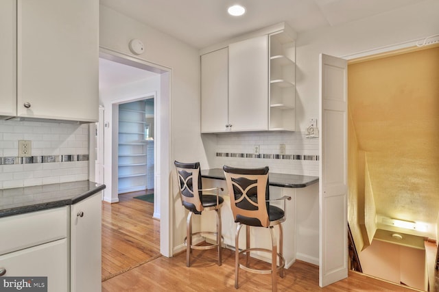 5811 Augusta Ln, Bethesda, MD 20816 - kitchen featuring open shelves, dark countertops, white cabinetry, and backsplash