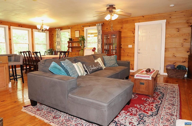 5254 Havenwood Ln, Schuyler, VA 22969 - living room with wood finished floors, a chandelier, wood walls, and a ceiling fan
