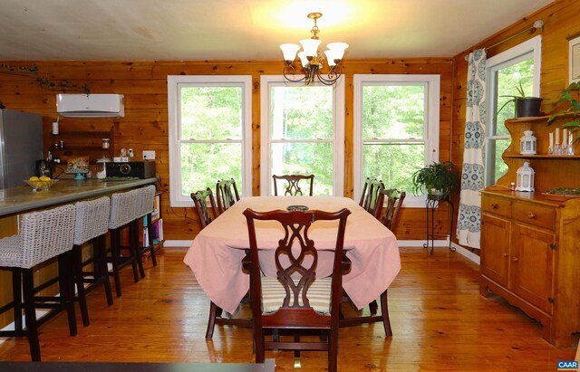 5254 Havenwood Ln, Schuyler, VA 22969 - dining area featuring a chandelier, light wood-type flooring, and wood walls