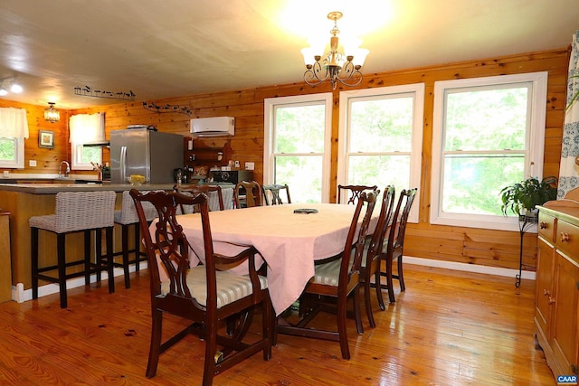 5254 Havenwood Ln, Schuyler, VA 22969 - dining area with healthy amount of natural light, wooden walls, a chandelier, and light wood-style floors