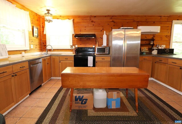 5254 Havenwood Ln, Schuyler, VA 22969 - kitchen featuring appliances with stainless steel finishes, a sink, wood walls, light tile patterned floors, and under cabinet range hood