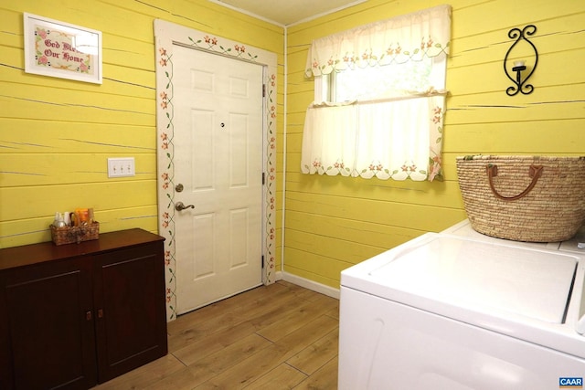 5254 Havenwood Ln, Schuyler, VA 22969 - laundry area featuring separate washer and dryer, wooden walls, light wood-style floors, and baseboards