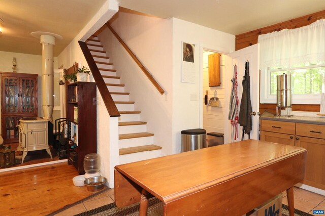 5254 Havenwood Ln, Schuyler, VA 22969 - dining area with light tile patterned flooring, stairs, and a wood stove