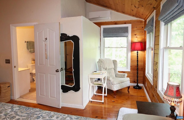 5254 Havenwood Ln, Schuyler, VA 22969 - bedroom with wood finished floors, lofted ceiling, a wall mounted air conditioner, wood ceiling, and wood walls