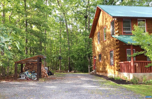 5254 Havenwood Ln, Schuyler, VA 22969 - view of side of home with log siding, metal roof, and driveway