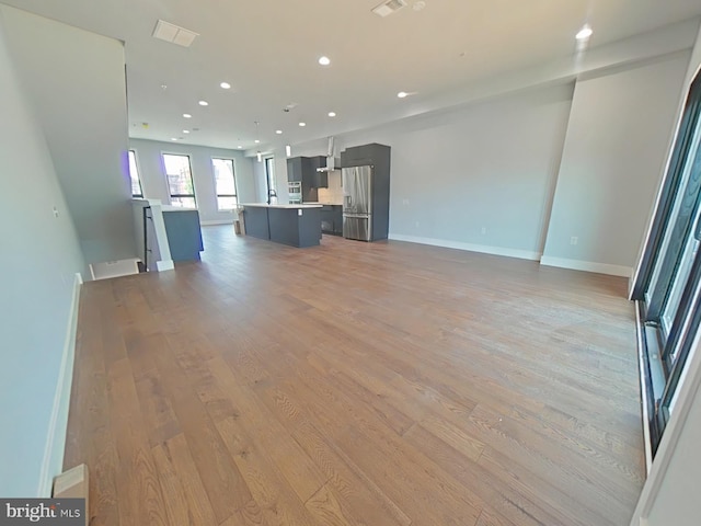 3143 W Montgomery Ave, Philadelphia, PA 19121 - unfurnished living room with light wood finished floors, recessed lighting, and baseboards