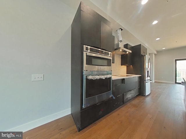 3143 W Montgomery Ave, Philadelphia, PA 19121 - kitchen featuring stainless steel appliances, baseboards, light countertops, modern cabinets, and wood finished floors