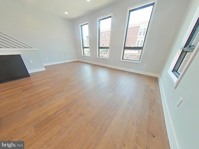3143 W Montgomery Ave, Philadelphia, PA 19121 - unfurnished living room featuring plenty of natural light, light wood-style flooring, baseboards, and recessed lighting