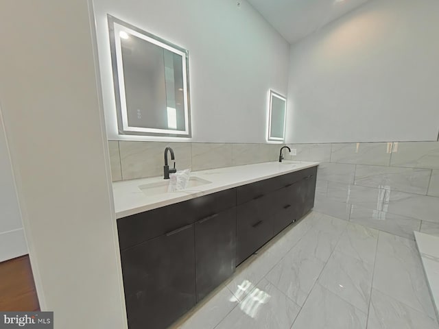 3143 W Montgomery Ave, Philadelphia, PA 19121 - full bath with tile walls, marble look tiles, double vanity, and wainscoting
