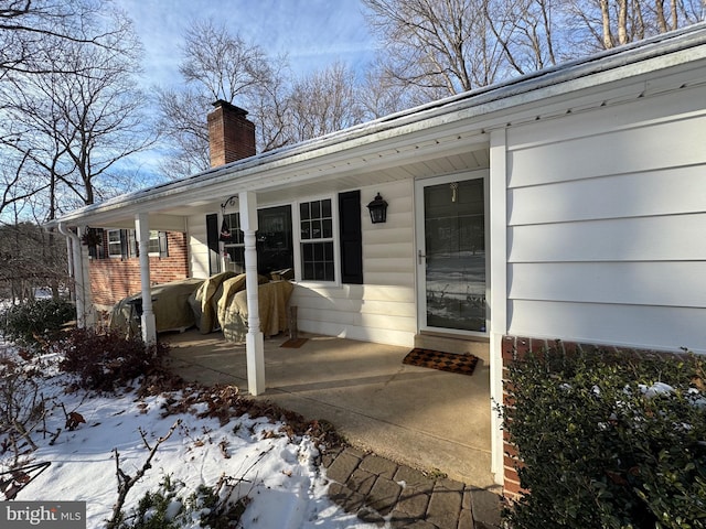 473 Linville Rd, Media, PA 19063 - snow covered property entrance featuring a chimney and covered porch