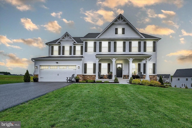 48 Winifred Dr, Hanover, PA 17331 - view of front of property featuring covered porch, driveway, an attached garage, stone siding, and a front yard