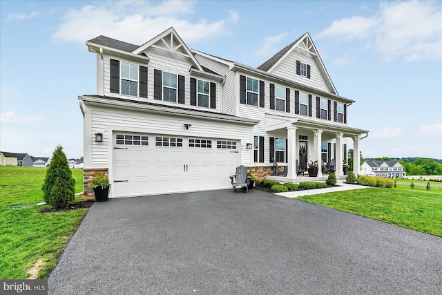 48 Winifred Dr, Hanover, PA 17331 - view of front facade featuring a porch, a front yard, asphalt driveway, and a garage