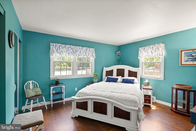 9000 Sudley Rd, Manassas, VA 20110 - bedroom with multiple windows, dark wood finished floors, and baseboards