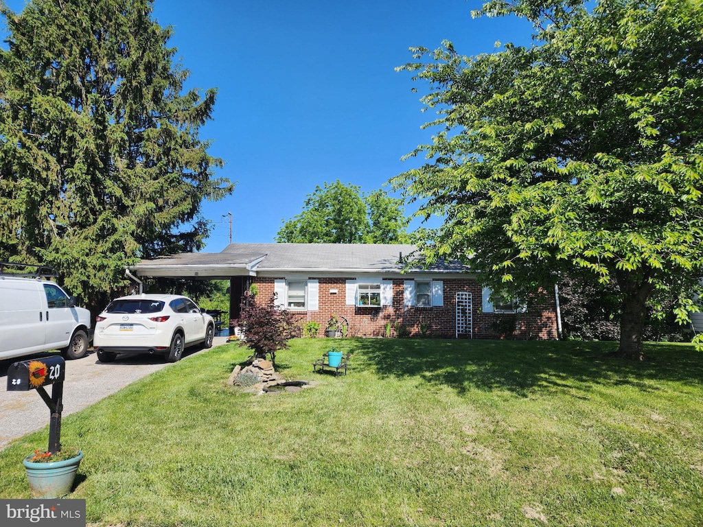 20 Locust Dr, Littlestown, PA 17340 - ranch-style home with a front lawn, brick siding, a carport, and driveway