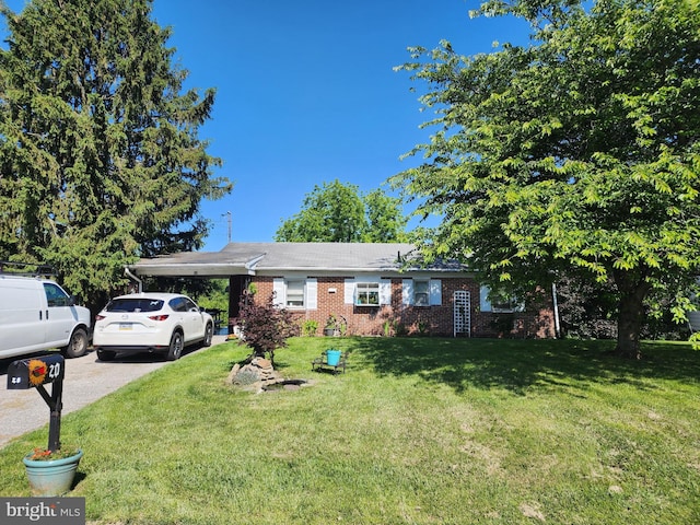 20 Locust Dr, Littlestown, PA 17340 - ranch-style home with a front lawn, brick siding, a carport, and driveway
