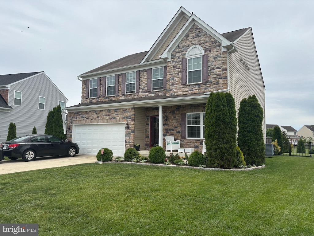 43 Autumn Ter, Magnolia, DE 19962 - craftsman-style house with stone siding, an attached garage, driveway, and a porch