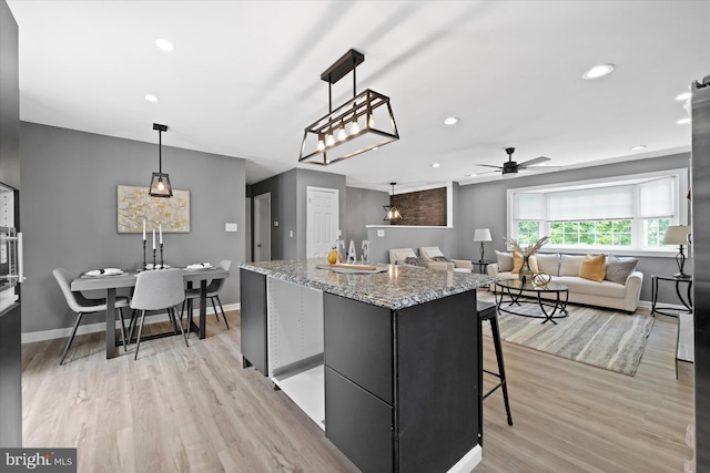 4 Hawkesbury Ct, Newark, DE 19702 - kitchen featuring a ceiling fan, a center island, light wood-style floors, baseboards, and recessed lighting