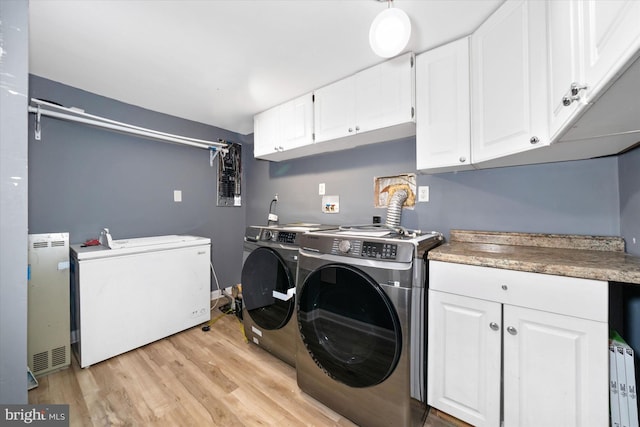 4 Hawkesbury Ct, Newark, DE 19702 - laundry room featuring separate washer and dryer, cabinet space, and light wood-type flooring